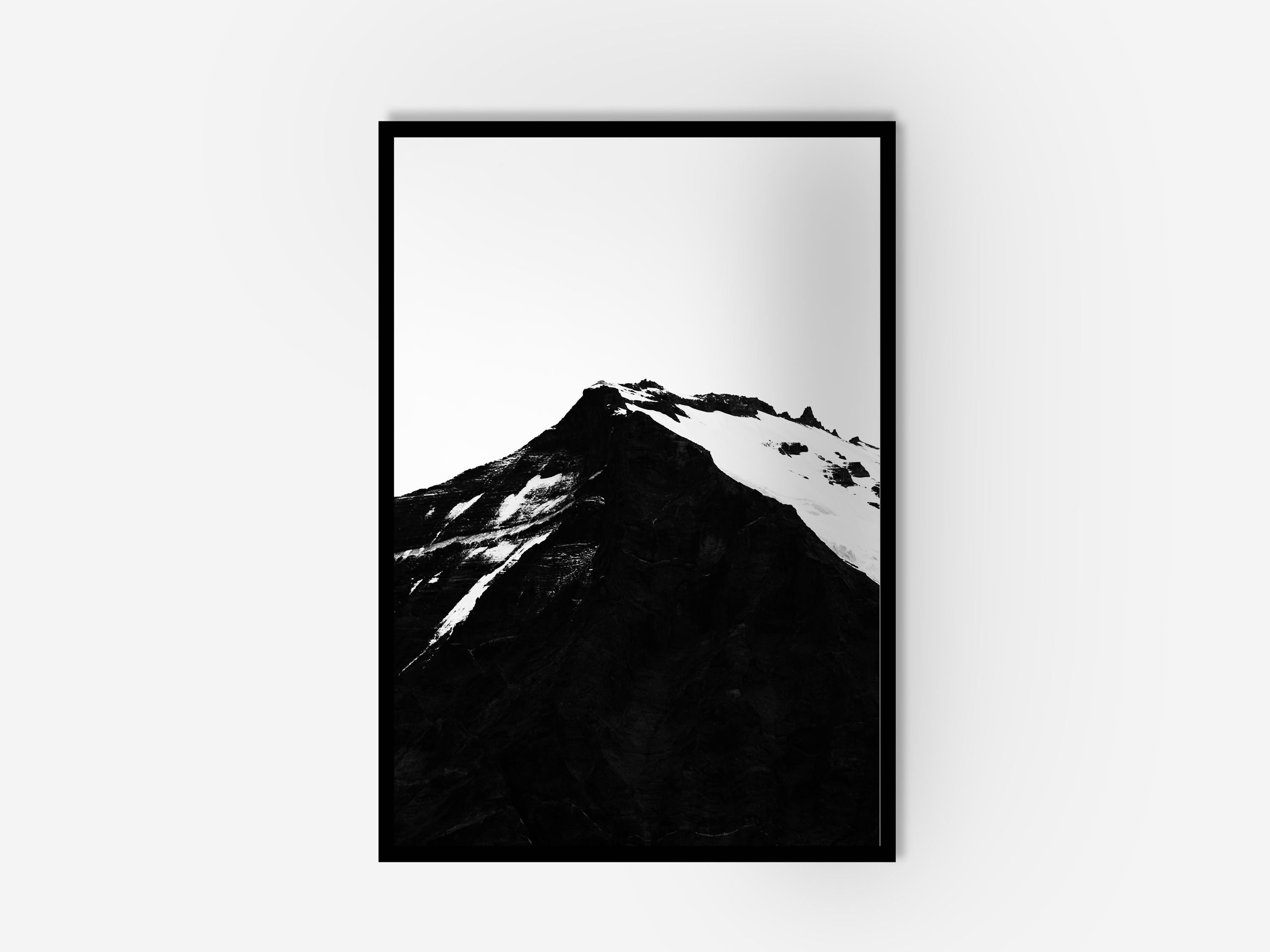 A framed black and white mountain photograph