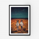 Framed wall art of two zebras standing in an orange field looking at a blue stormy sky.