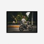 A wall art print of a motorcyclist with a Jamaican flag raggae hat