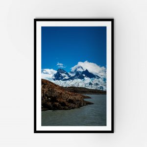 A framed photo of a mountain range under a clear blue sky.