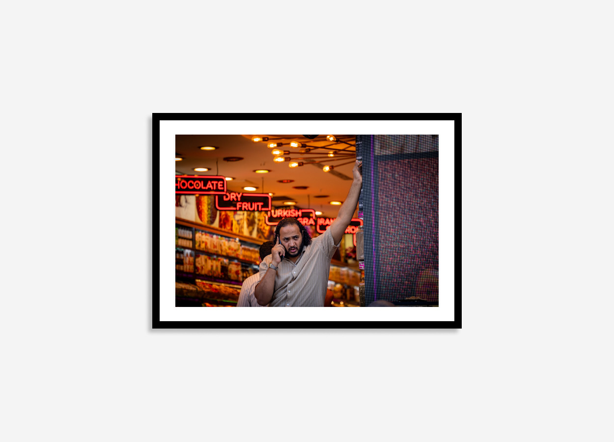 talking turkey man standing in front of a shop candit photoshoot