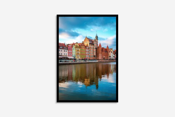 Gdansk, Poland colorful street buildings reflected vividly in the calm river, showcasing vibrant architecture and serene waterscape at sunset.
