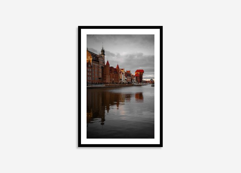 Gdansk riverside scene featuring historic buildings and a large crane, rendered in striking red and black hues reflecting on the water.