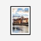 Colorful historic buildings lining the Motława River in Gdańsk, Poland, showcasing charming architecture and vibrant waterfront views.