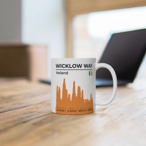 White ceramic mug featuring a detailed Wicklow Way trail map and scenic Irish countryside design, perfect for hiking enthusiasts.