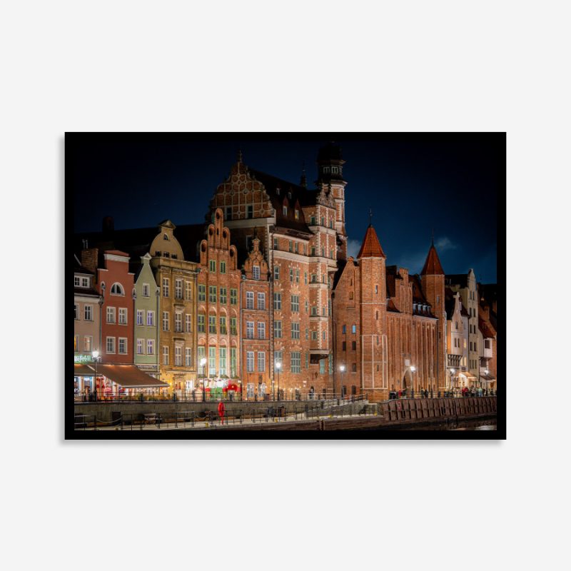 Gdansk buildings glowing at night with historic Gothic and Renaissance architecture, city lights, and reflections along the tranquil riverfront