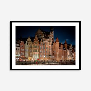 Nighttime print of Gdansk buildings showcasing illuminated historic architecture and vibrant cityscape under a dark sky.