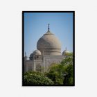 Taj Mahal’s iconic white marble mausoleum framed by vibrant green trees, highlighting its perfect symmetry and exquisite Mughal architectural details in this wall art print.