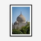 Taj Mahal viewed through lush green trees, showcasing iconic white marble architecture; wall art print highlights historic Indian landmark.